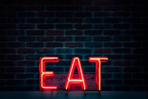 neon sign that reads 'eat'